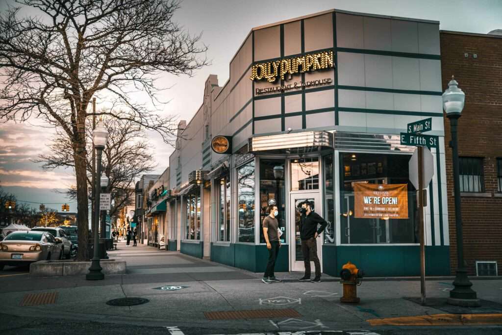 Jolly Pumpkin Restaurant and Taphouse on a street corner with other shops and street parking
