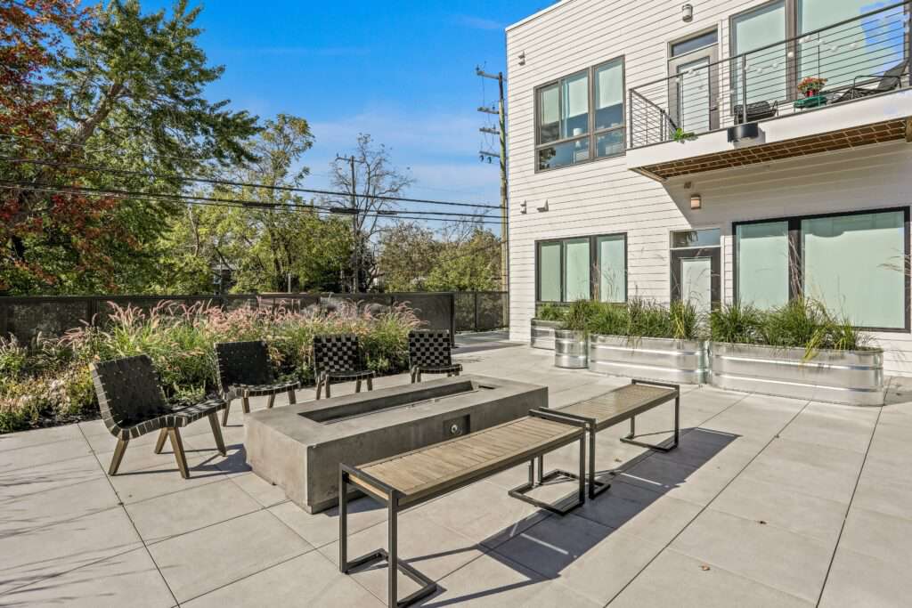 Outdoor fire pit and seating area in the courtyard at The Roy Apartment.