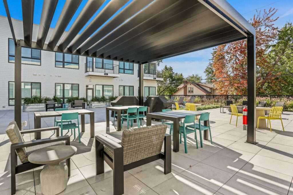 Outdoor seating and grilling area in courtyard at The Roy Apartments